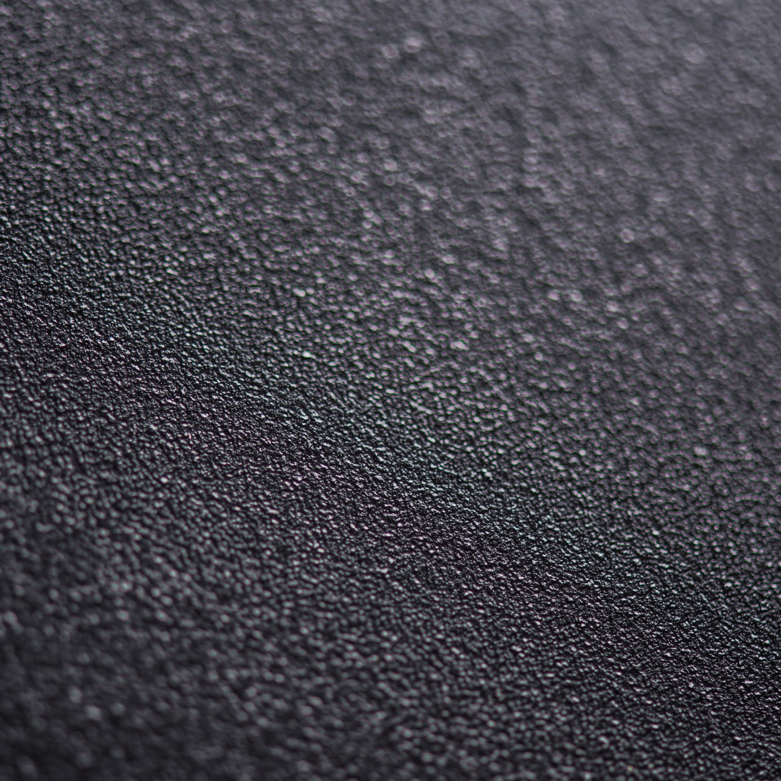 dark atomised powder showing varied particle size and morphology