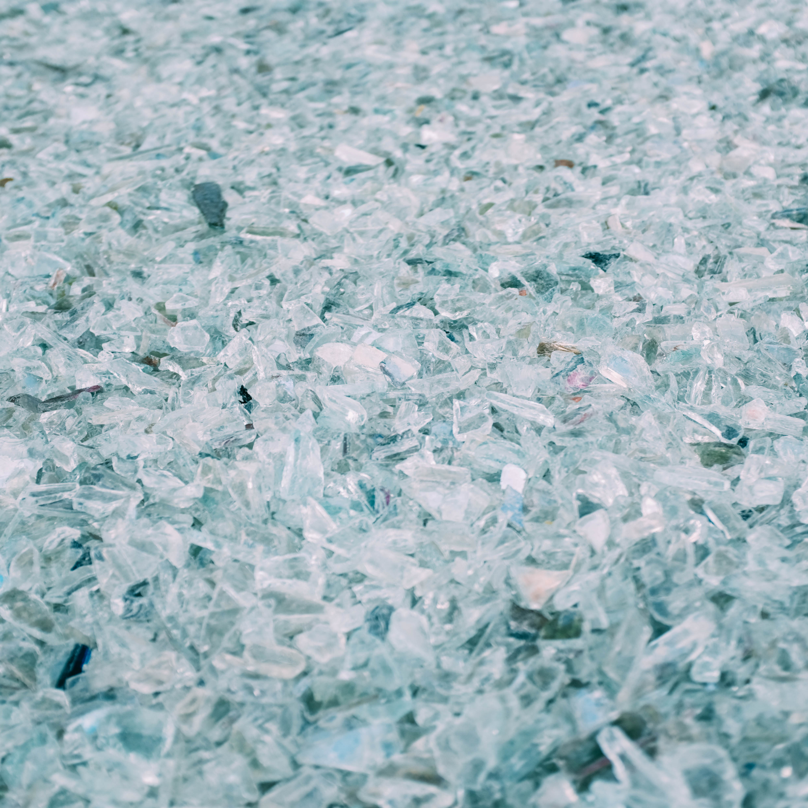 Crushed recycled glass ready for particle size classification and industrial recycling.