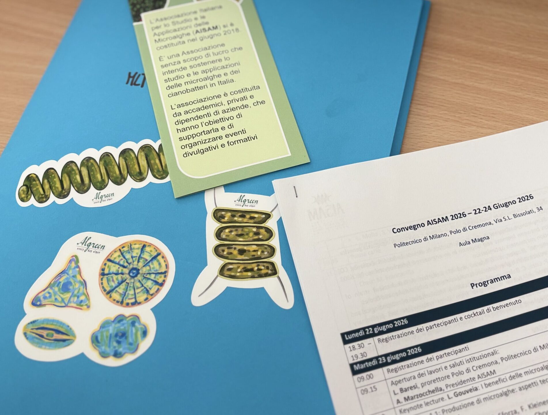 AISAM 2026 conference program and microalgae illustrated stickers by Algreen, Politecnico di Milano