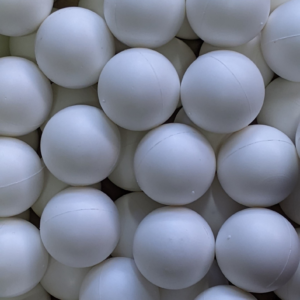 Close-up of white rubber cleaning balls used under vibrating screen mesh