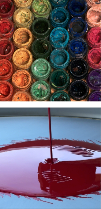 Colored paint pigment jars above a viscous coating being filtered on a vibrating sieve